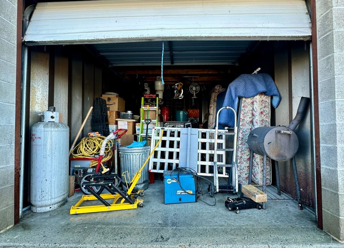 Open garage packed with items awaiting a residential junk removal cleanout